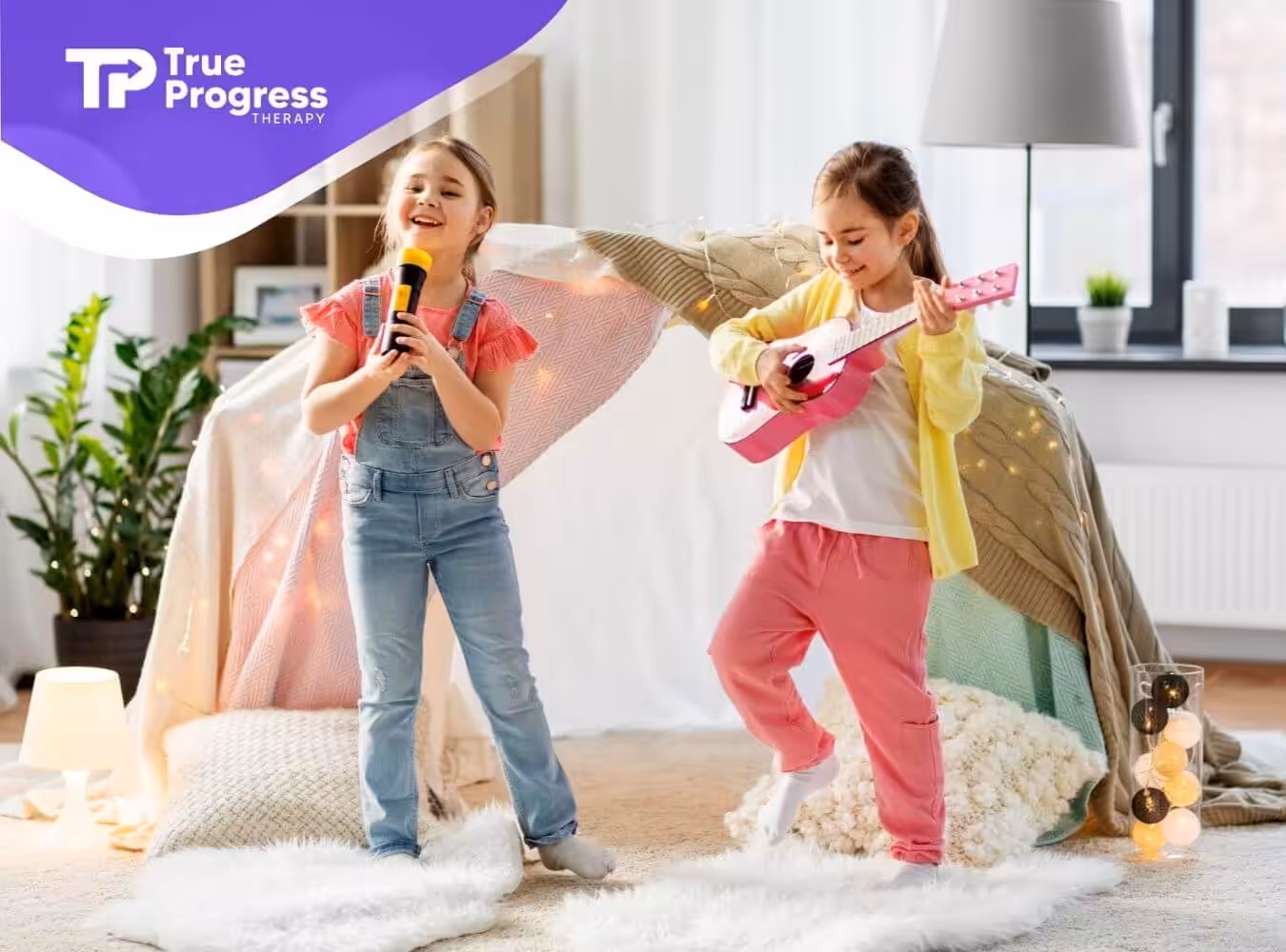Two girls with autism singing and playing guitar in a cozy room.