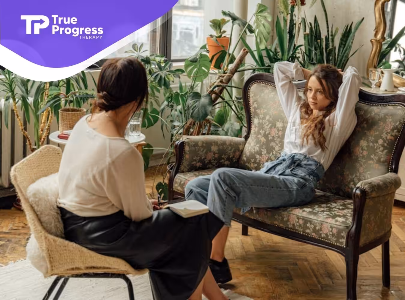 An autistic patient reclines on a couch while talking to an ABA therapist at a room in New Jersey.
