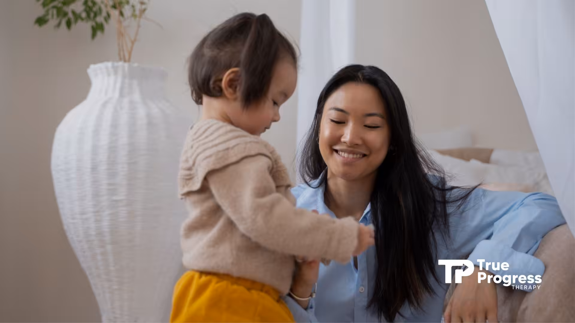 A toddler interacting with a caregiver, demonstrating ABA therapy techniques in a comfortable setting.