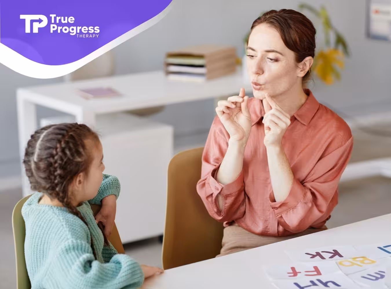 BCBA and autistic girl looking at each other during ABA therapy session.