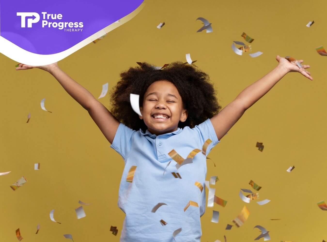 Smiling child with arms raised, surrounded by falling confetti.
