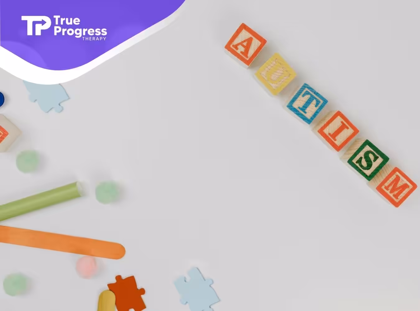 Autism spelled with colorful wooden blocks against a white background, symbolizing autism statistics in New Jersey.