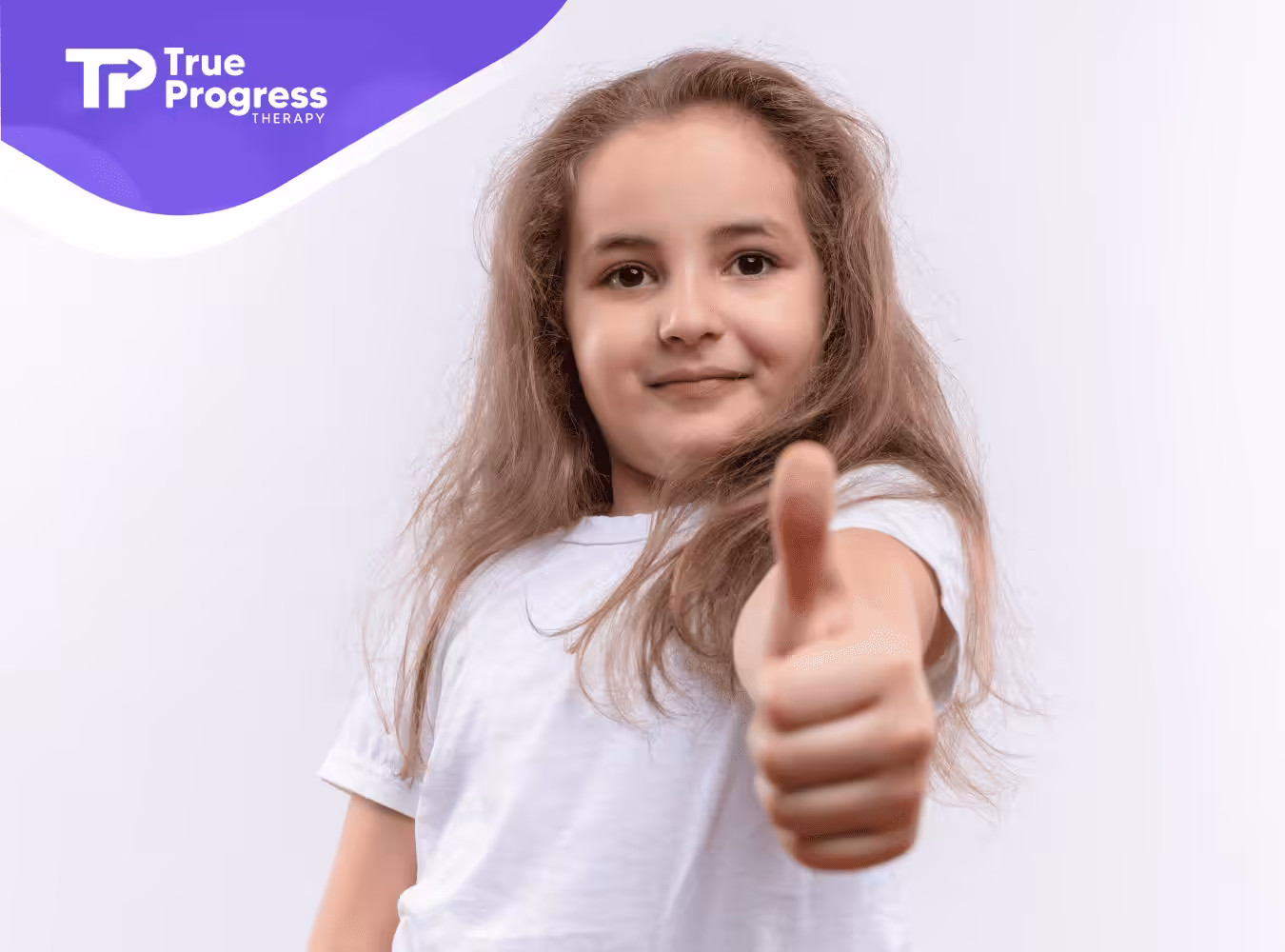 A girl in a white shirt holding her thumbs up