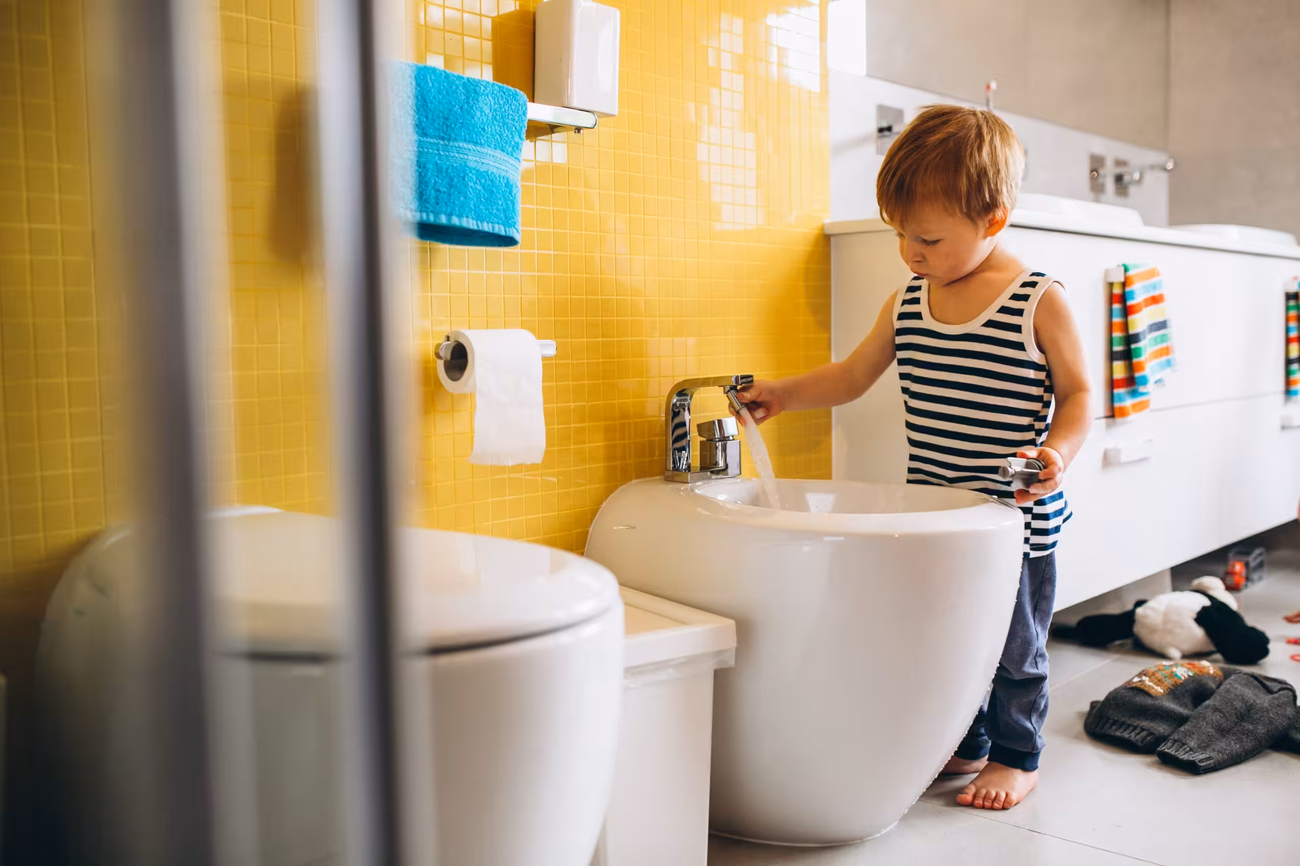 A child with autism is washing his hand.