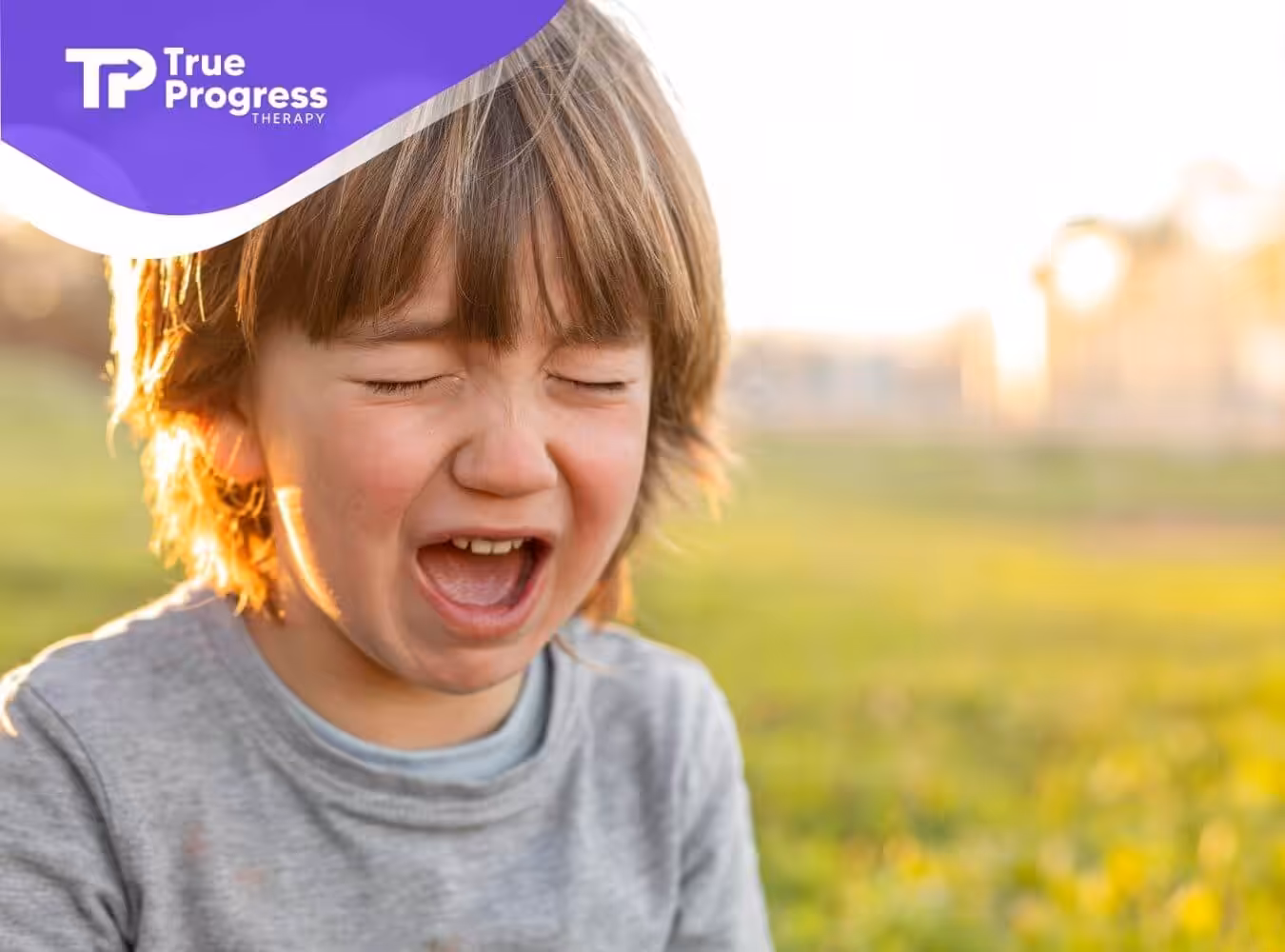 Autistic boy crying outdoors after ABA therapy.