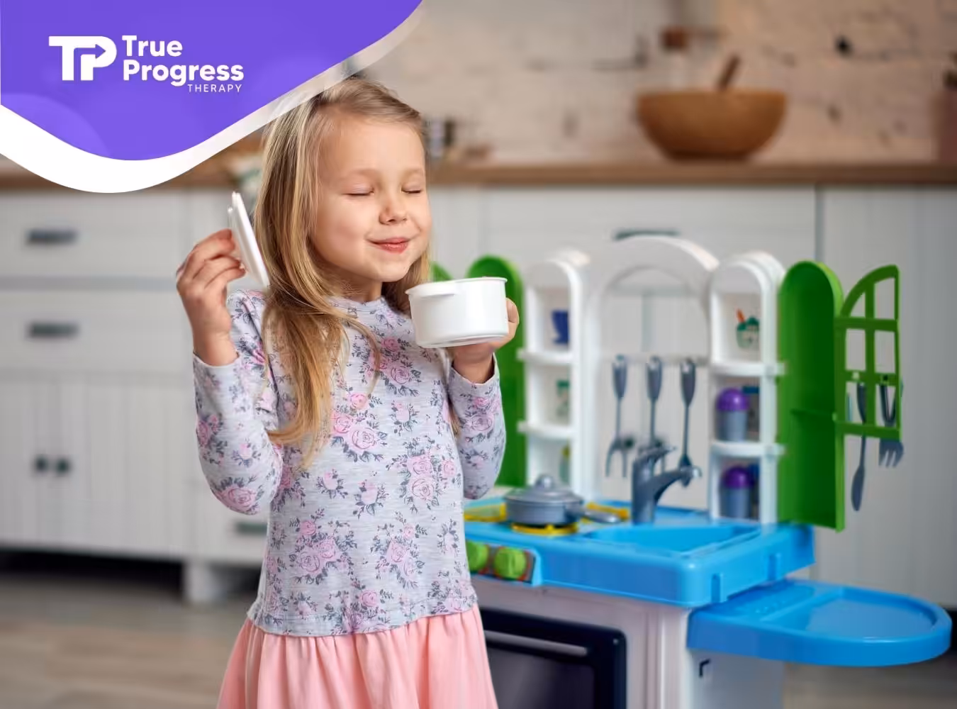 Little autistic girl pretending to drink tea in a play kitchen during in-home ABA therapy in New Jersey.