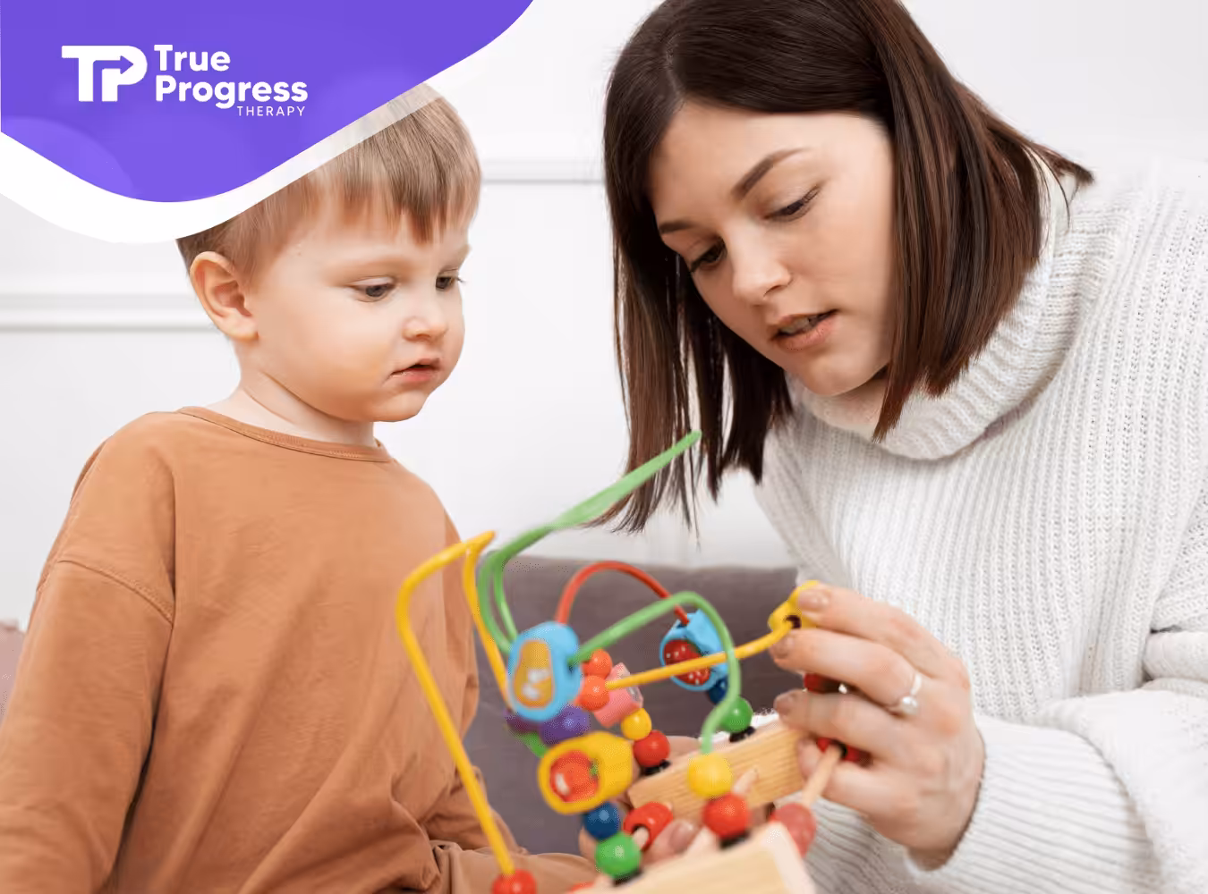 An RBT and a kid with autism playing with an education toy during ABA therapy