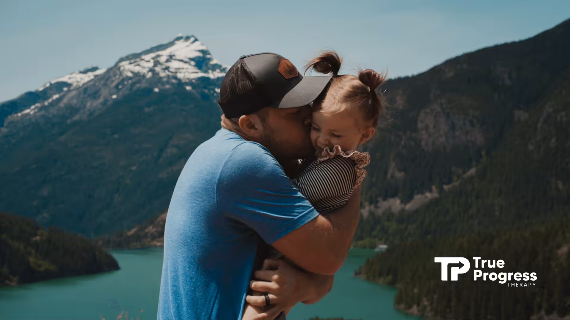 Autistic father embracing and kissing his autistic daughter with a beautiful mountain landscape in New Jersey.