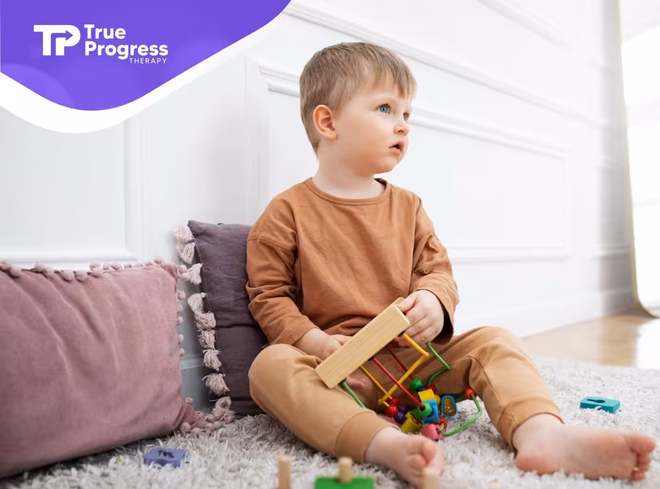 A young boy engaged in sensory play during home-based ABA therapy session.