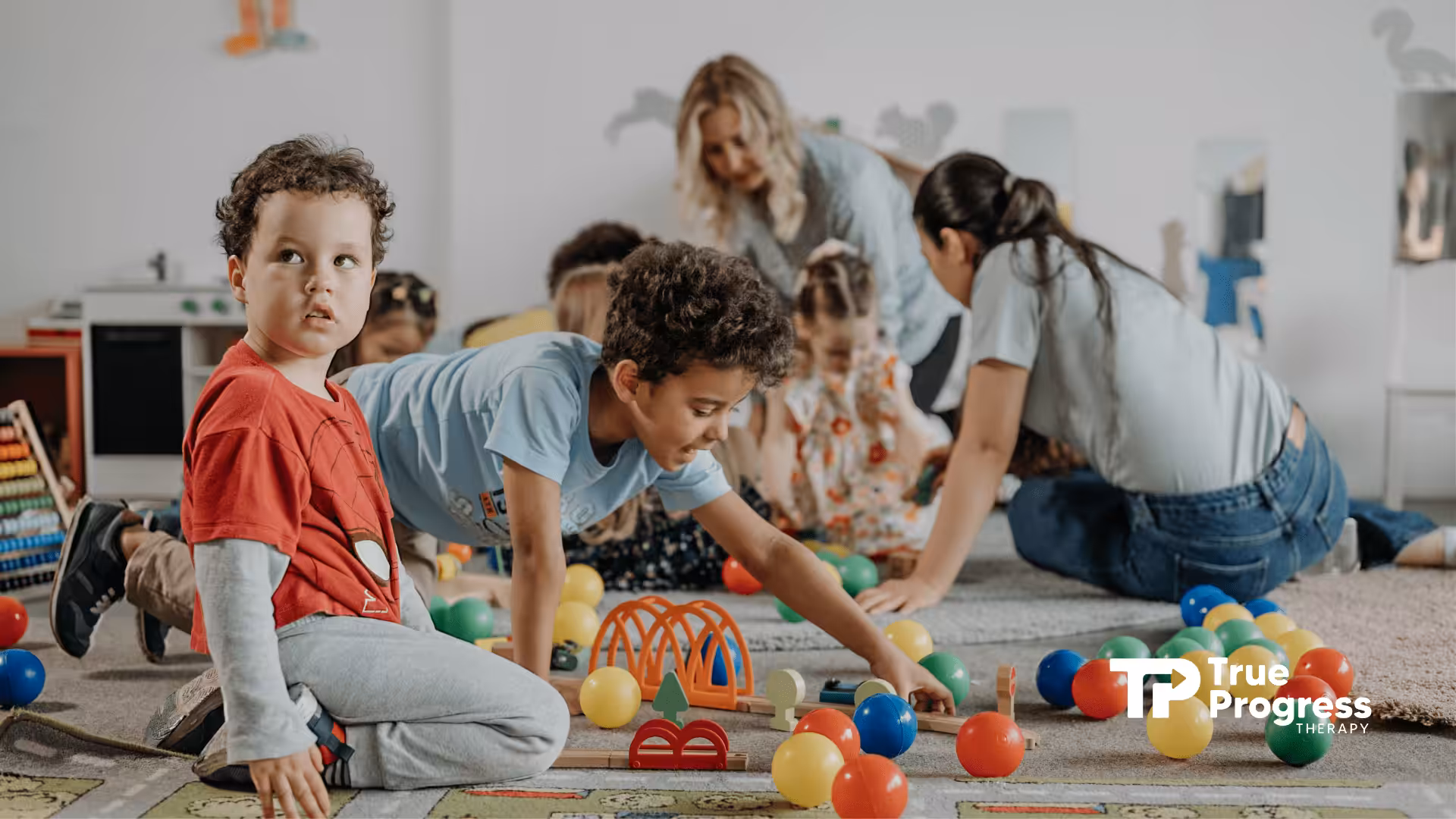 Children with autism playing with colorful balls during ABA therapy.