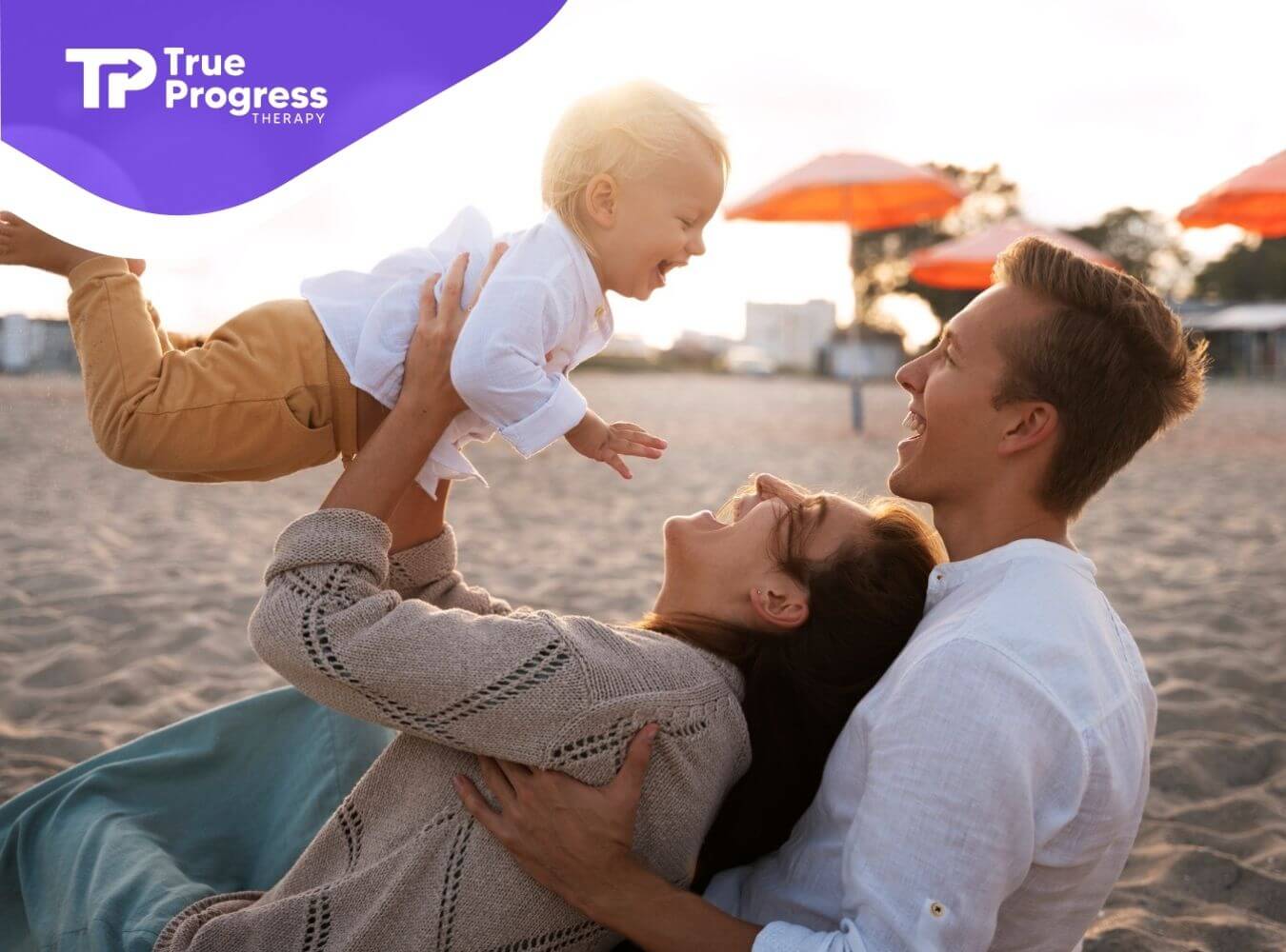 Mother holding autistic child while father watches.