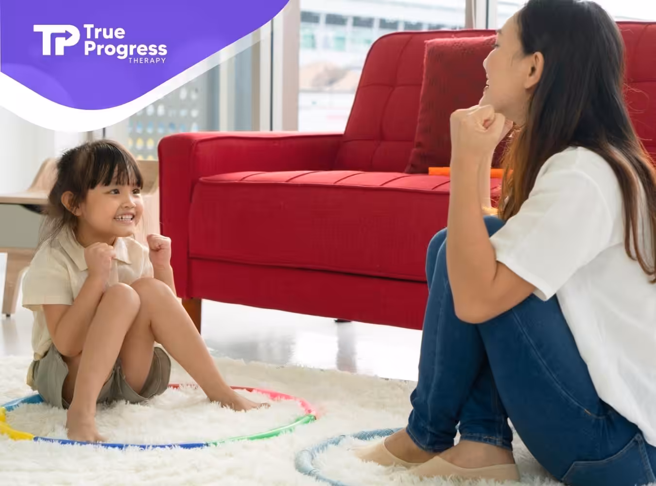 A therapist using ABA therapy techniques with a smiling child.