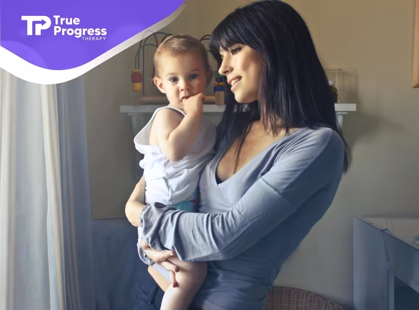 An ABA therapist holding toddler near a window, both looking outside during ABA therapy session in New Jersey.