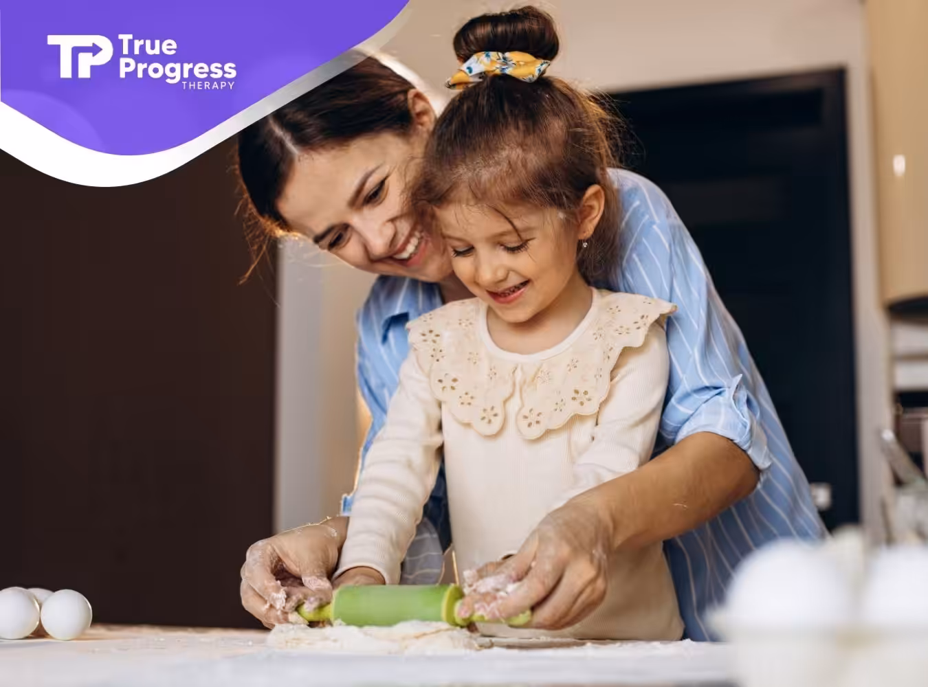 BCBA and autistic child baking together in the kitchen.