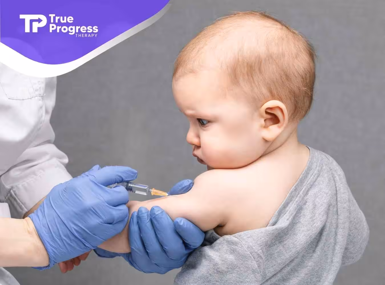 A baby receiving a vaccine in the arm from a healthcare worker wearing blue gloves. The baby looks pensive. The setting conveys a professional tone.