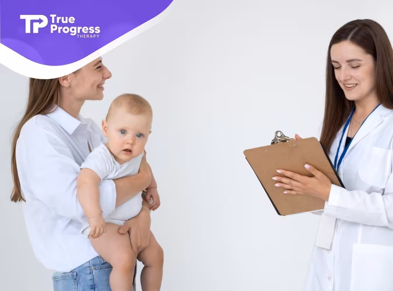A mother holds her baby with autism while a doctor smiles and talks to her in a clinic.