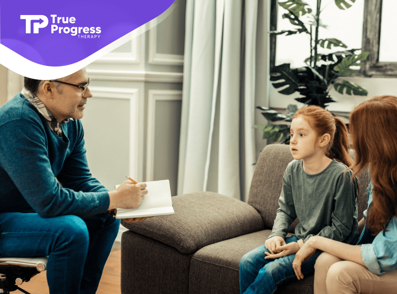 BCBA speaking with a young girl and parent during ABA therapy session.