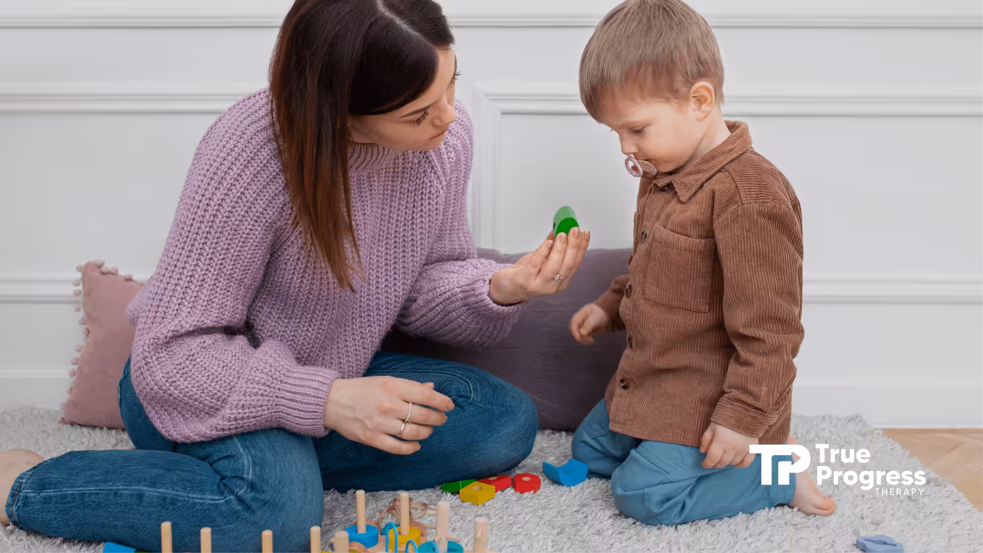 An RBT and a little boy playing during their ABA therapy session