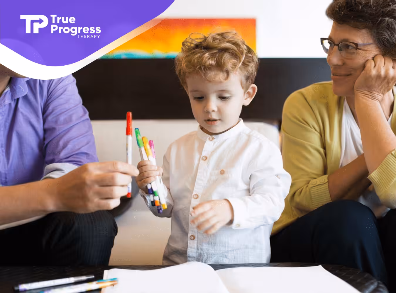 A child playing with markers on a table