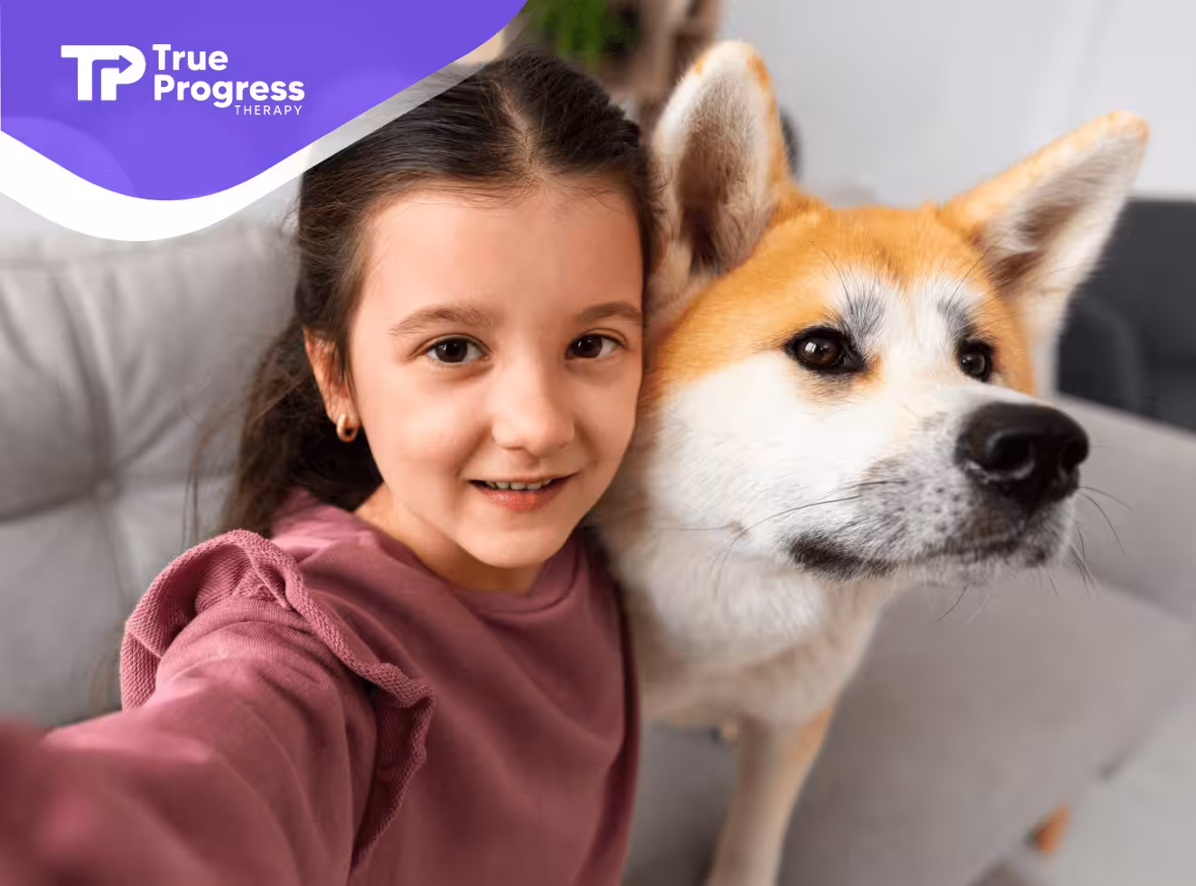 A girl taking a selfie with her pet dog