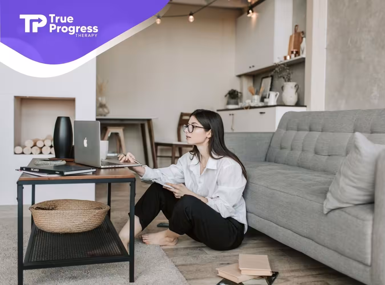 An RBT aspirant sitting on the floor, studying and taking notes at a cozy living room in New Jersey.