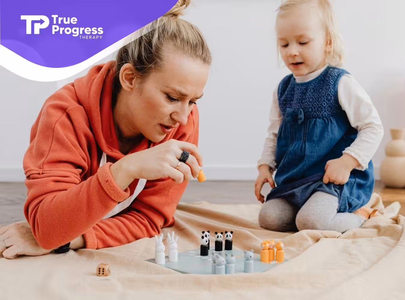 An RBT and autistic child playing a board game with animal pieces during in-home ABA therapy session in New Jersey.