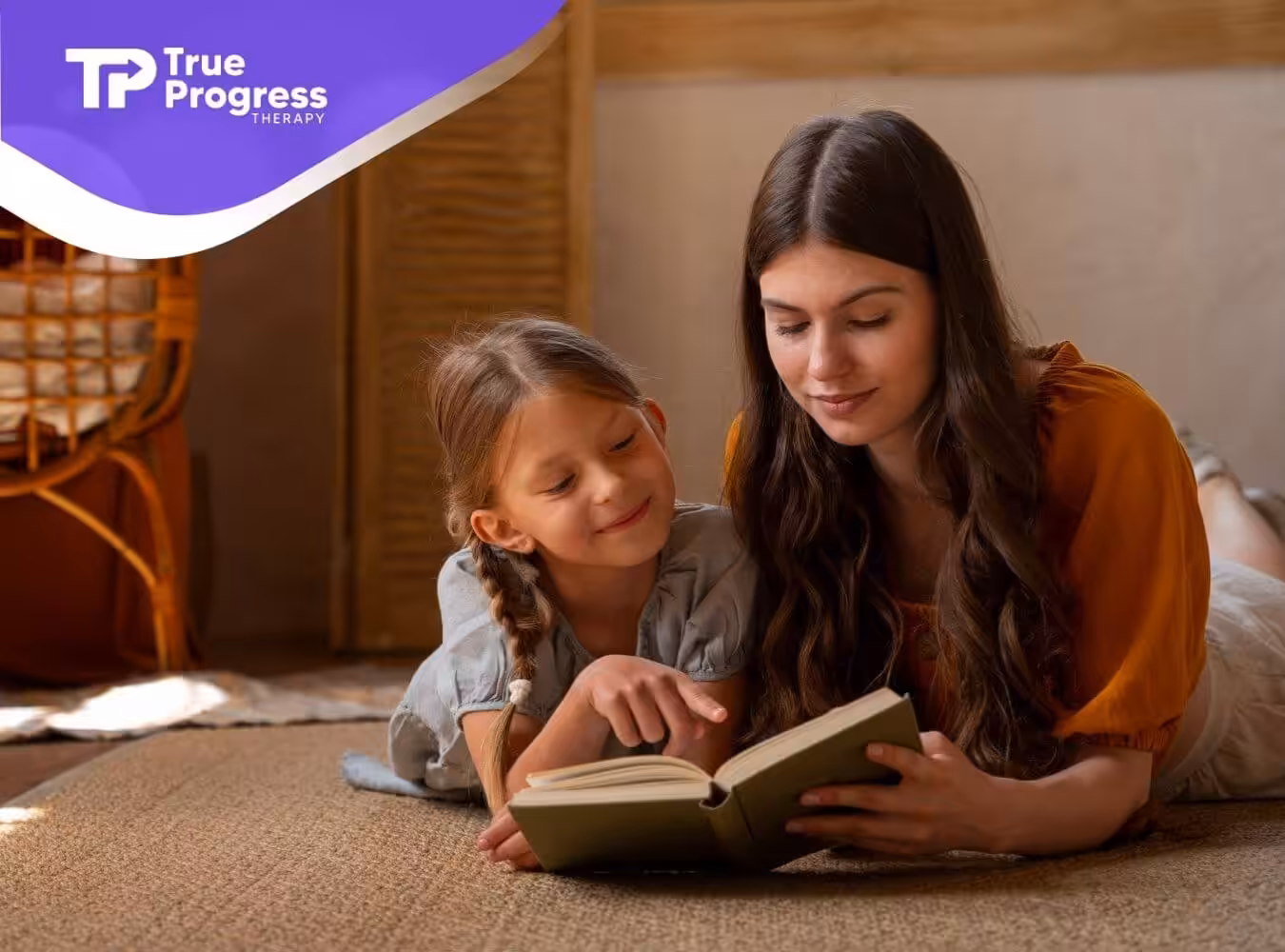BCBA and autistic girl reading a book together in ABA therapy.