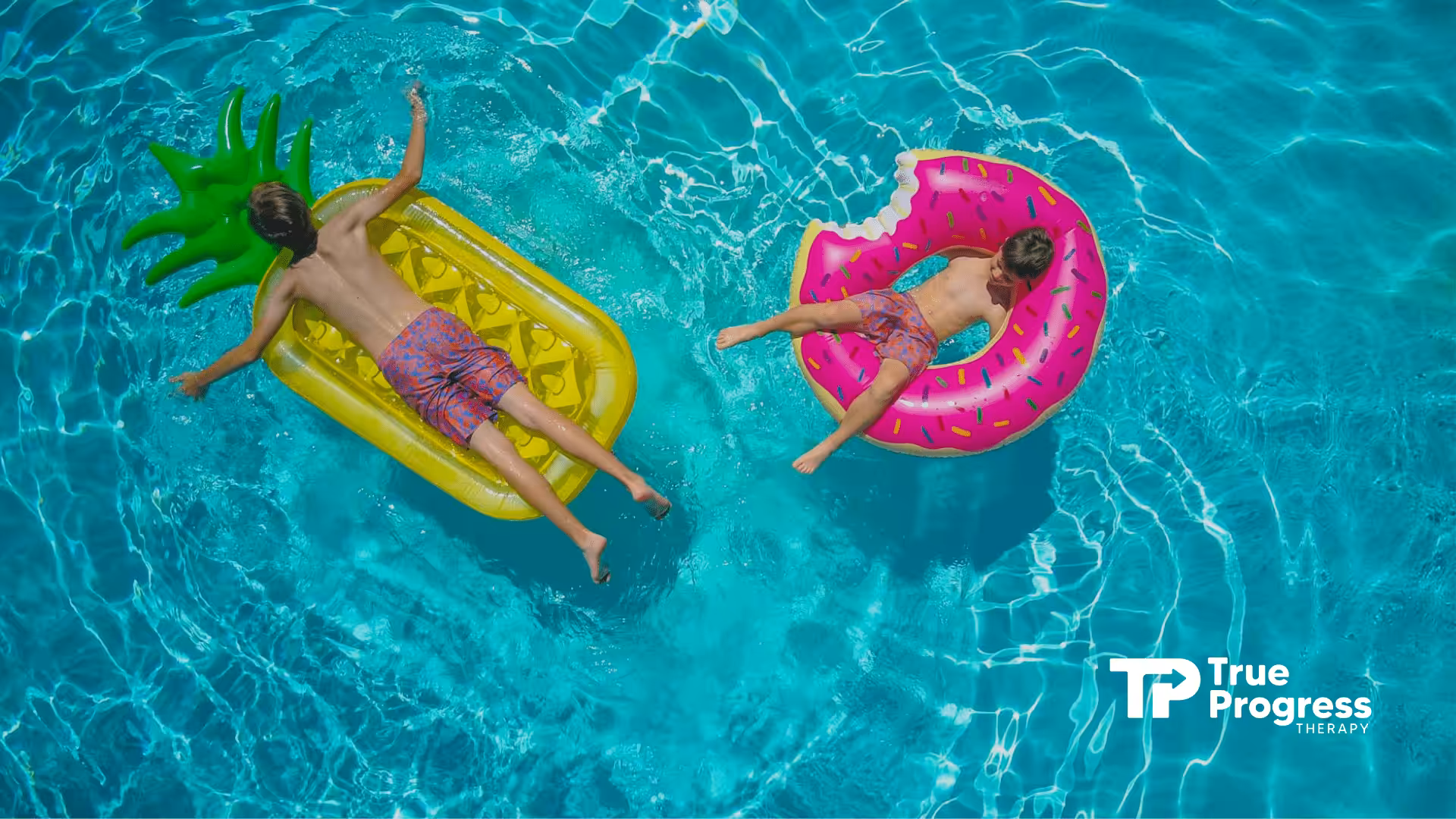 Autistic boys floating and relaxing on inflatable toys at a bright blue swimming pool in New Jersey.