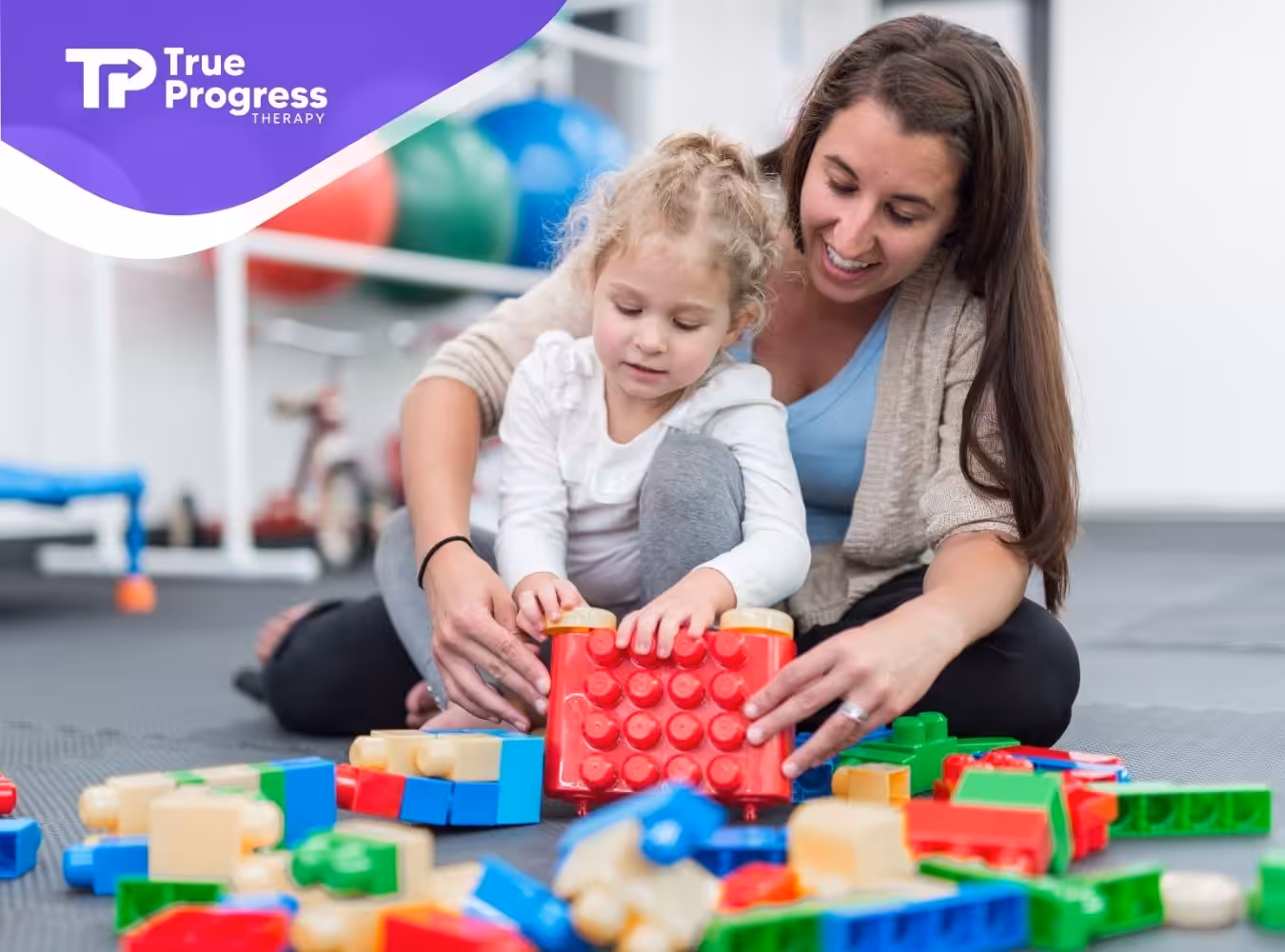 A little girl doing blocks with her RBT.
