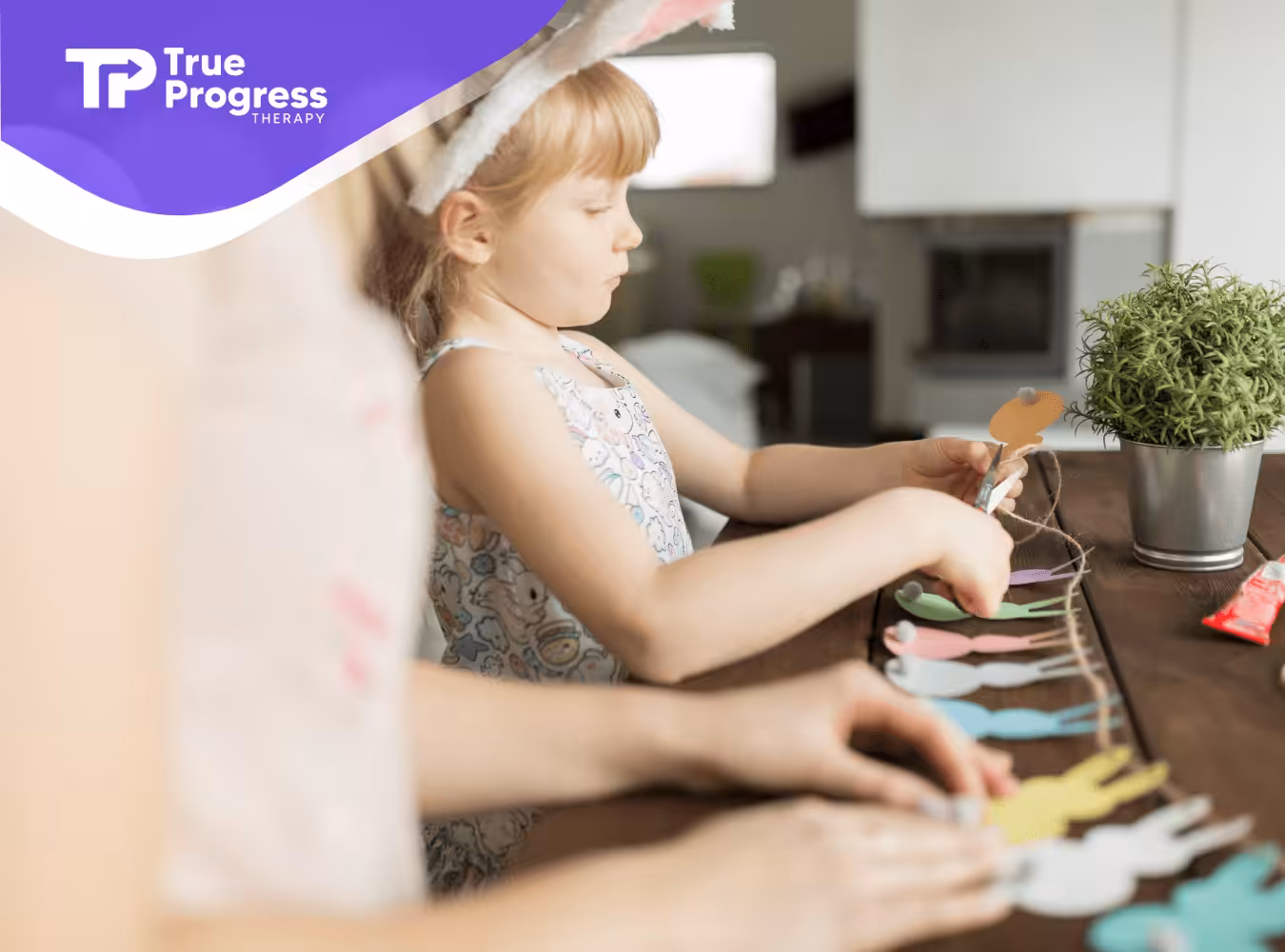 A girl with autism and her mother are making a garland