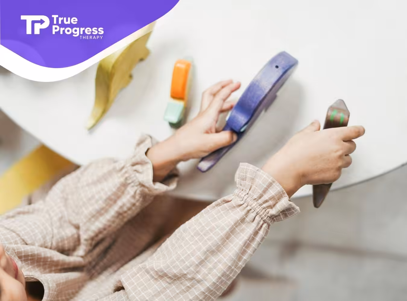 A child with autism engaging with colorful wooden toys during ABA therapy on a white table in NJ.