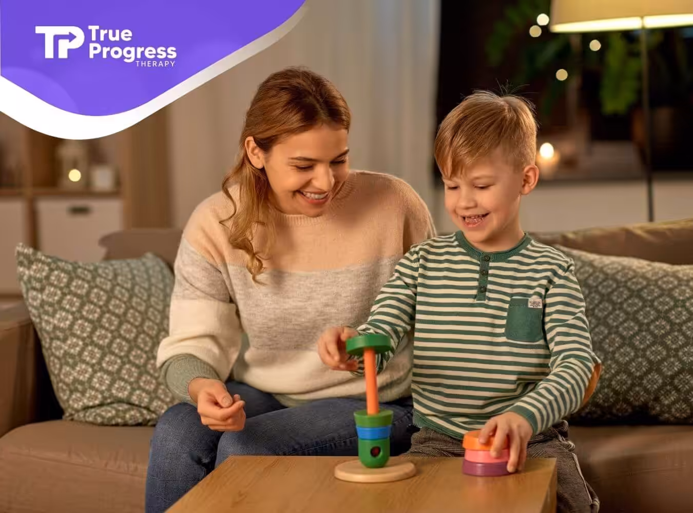 BCBA and autistic boy playing with stacking toy in ABA therapy.