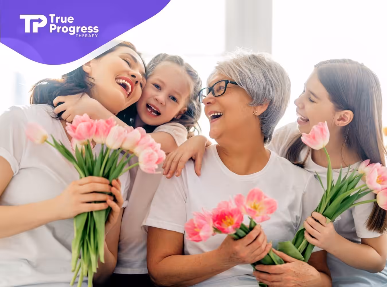 Generational women in a family, posing with flowers.