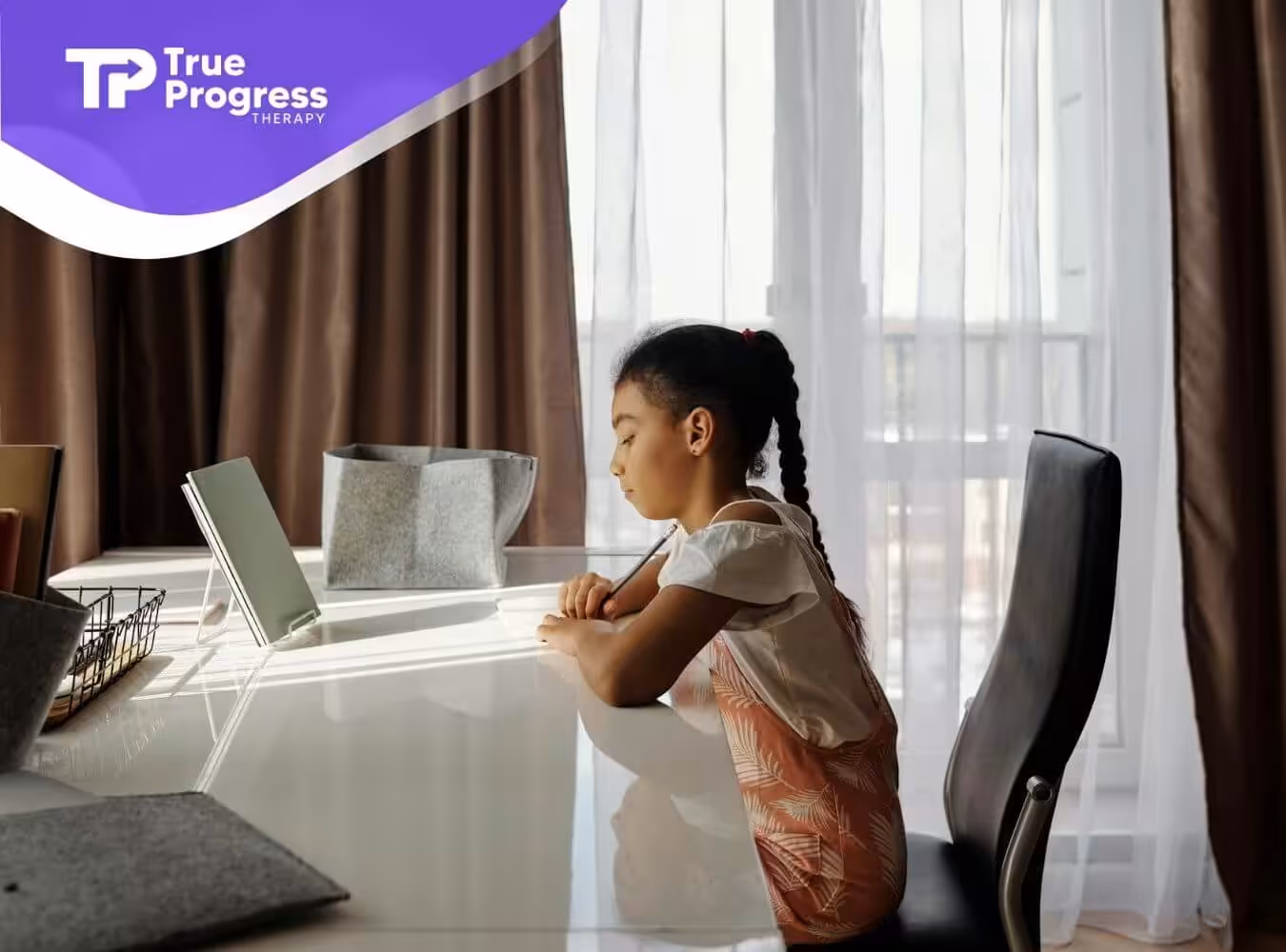 The autistic child focused on a tablet, working at a desk in a well-lit room after ABA therapy in New Jersey.