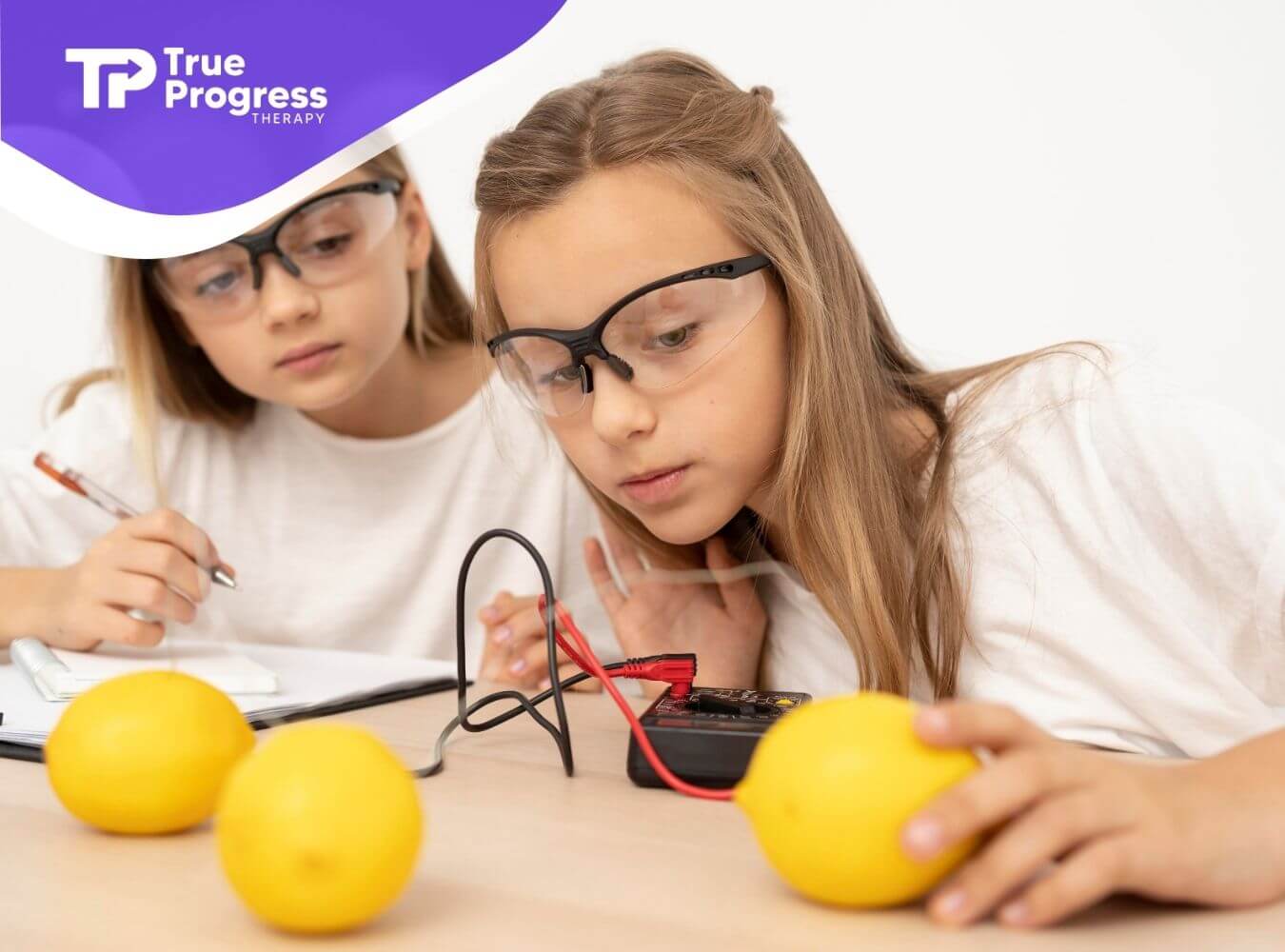 Two autistic kids wearing safety goggles conduct a hands-on science activity, exploring learning through experimentation
