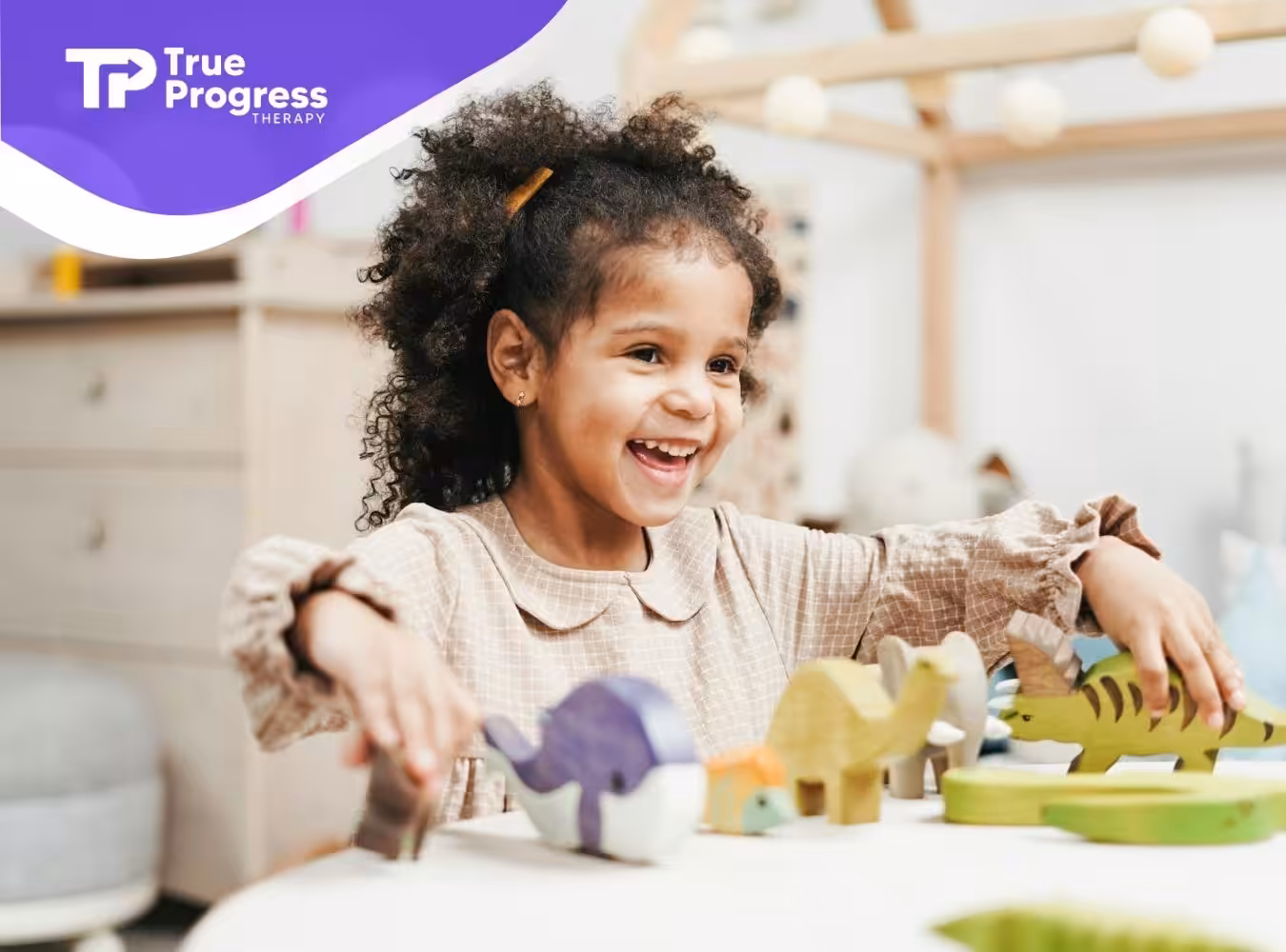 A happy autistic child playing with colorful wooden animal toys on a table at home in New Jersey.
