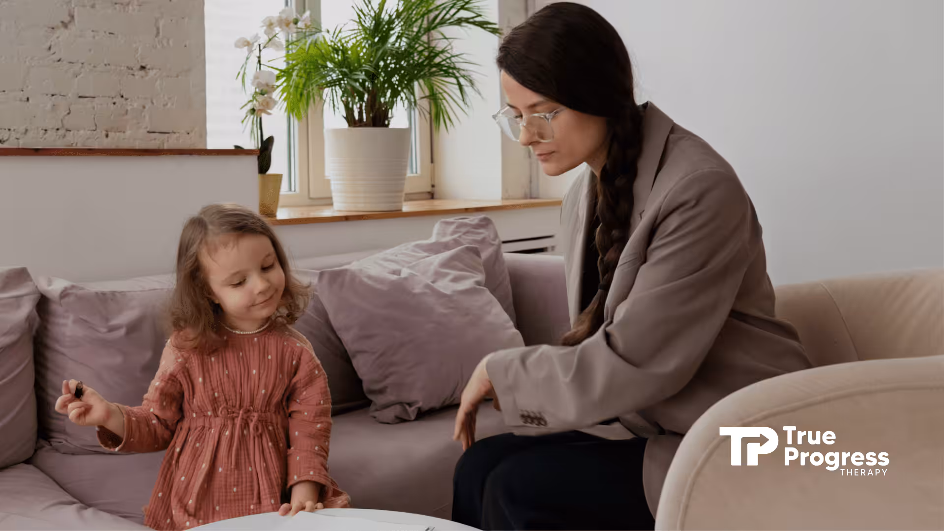 An RBT and a girl talking during their ABA therapy session