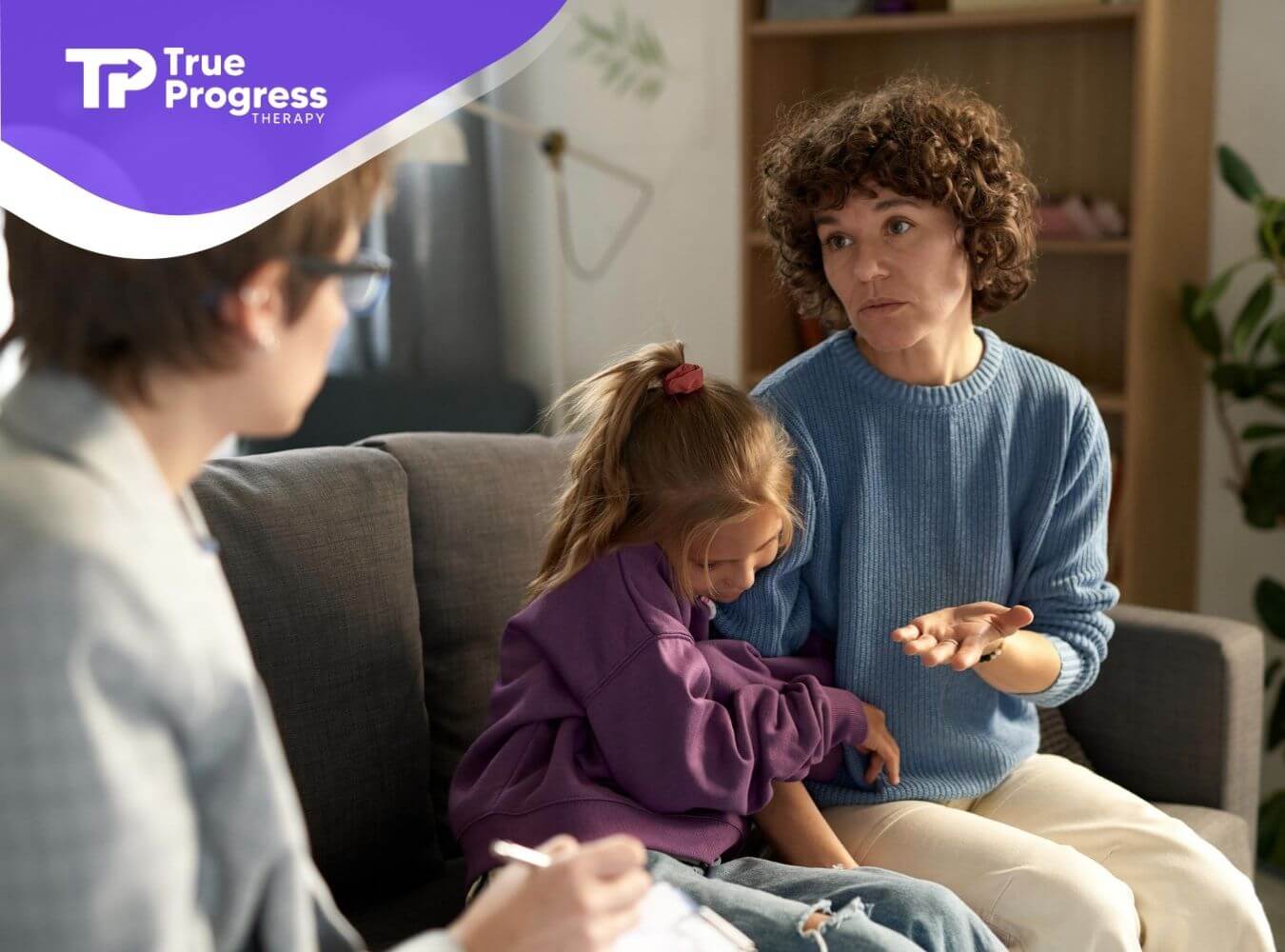 Parent and child speaking with a BCBA during autism evaluation.