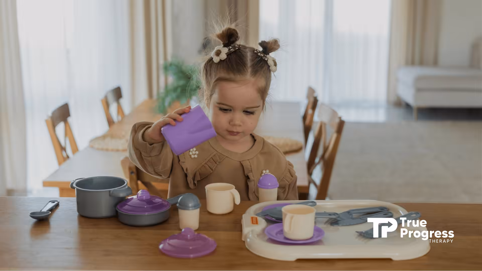 Young autistic girl playing with colorful toy cups and kitchen accessories on a table during in-home ABA therapy in NJ.