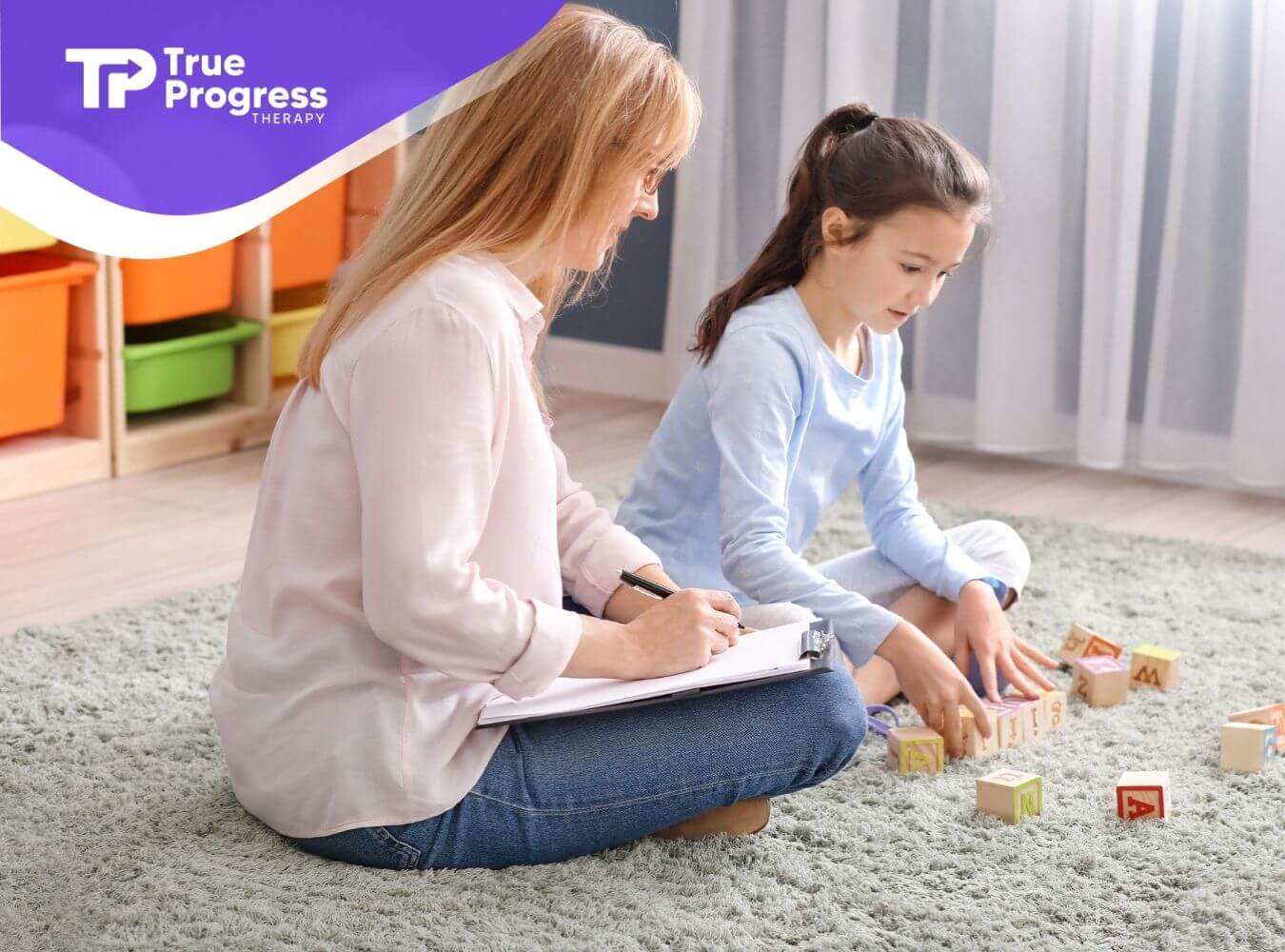 BCBA sits with a young girl on a carpeted floor during in-home ABA Therapy.