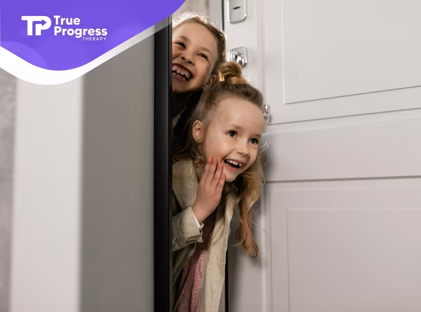 Two happy autistic kids peeking and laughing from behind a door during in-home ABA therapy in New Jersey.