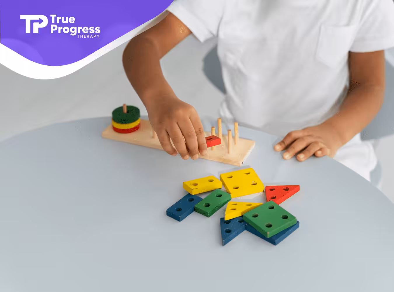 A boy playing with colorful blocks on a table
