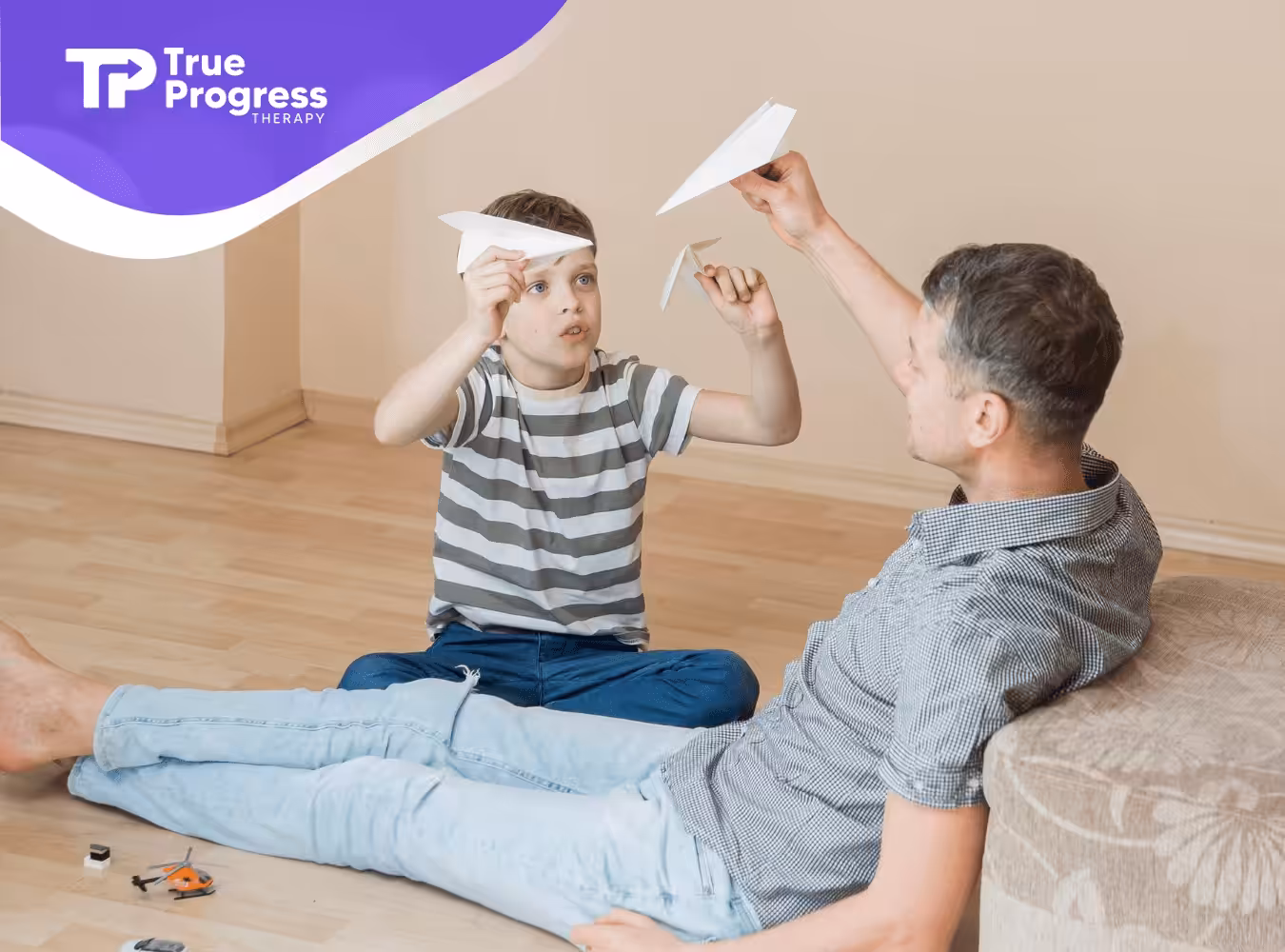 A boy and his guardian are playing with paper planes