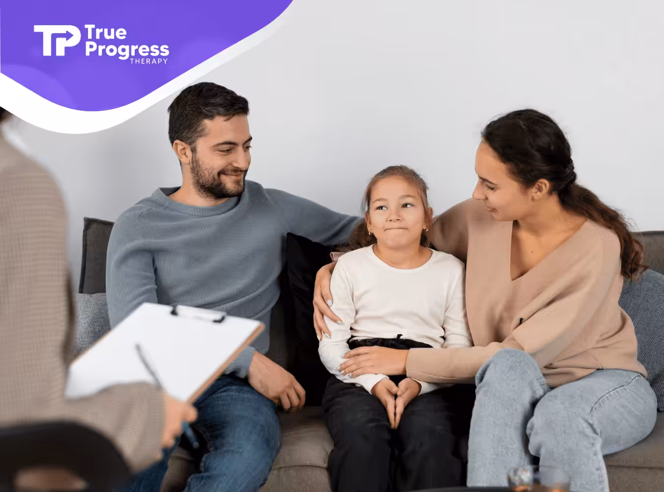 A family with autistic daughter talking to ABA therapist.