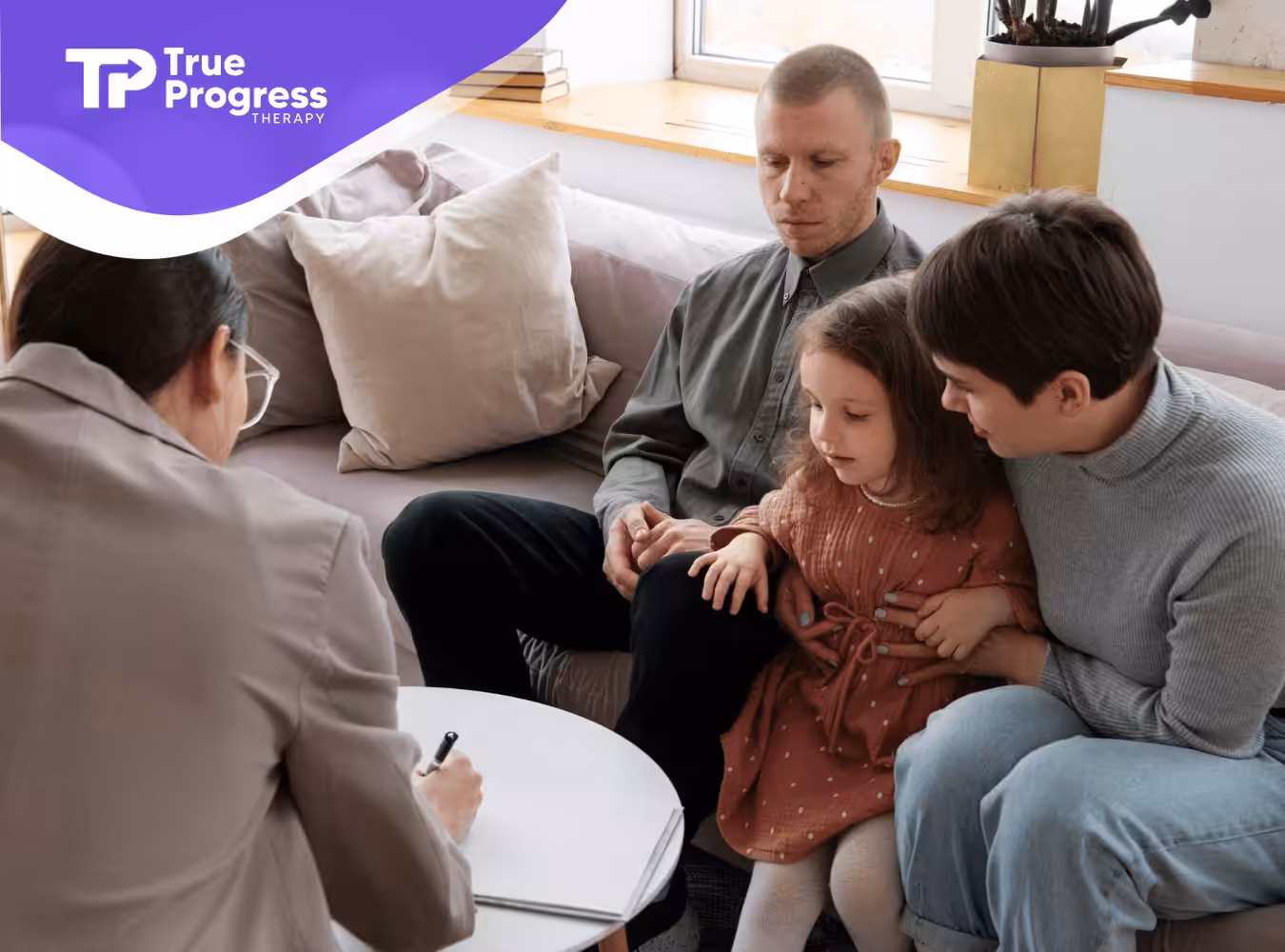 A family with autism talking to a therapist.