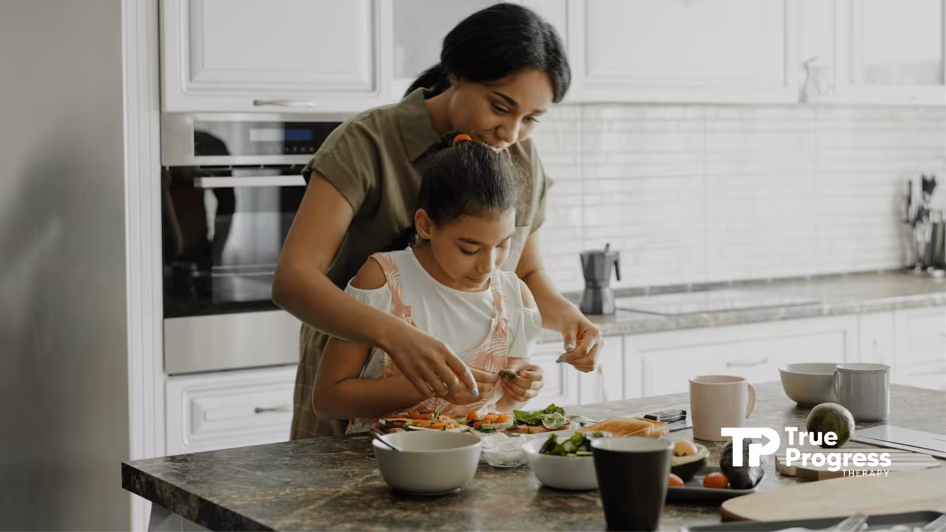 An RBT using discrete trial training to an autistic child as they prepare food in a kitchen in NJ.