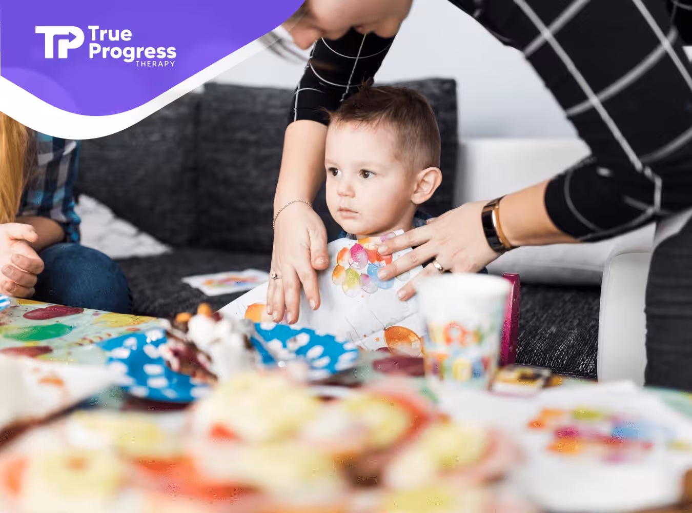 An RBT helping a boy with autism with his art activity during ABA therapy