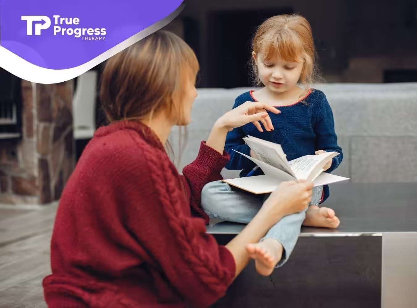 A BCBA reading a book with a young girl with autism, who is pointing at the pages.