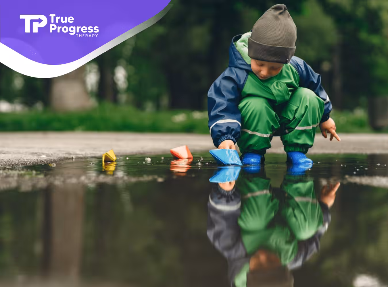 An autistic child playing with a puddle outdoors