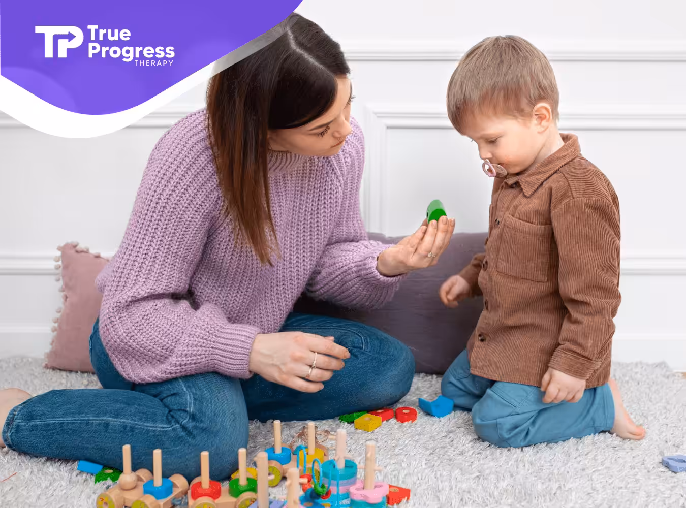 An ABA therapist and a child with autism playing during ABA therapy